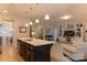 Modern kitchen with island, stainless appliances, and open view to the living room at 3156 Pinehills Way, Mount Holly, NC 28120