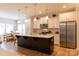 Spacious kitchen with a large center island, stainless appliances, and modern pendant lighting at 3156 Pinehills Way, Mount Holly, NC 28120