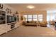 Cozy living room with neutral tones, comfortable seating, and a view of the kitchen at 3156 Pinehills Way, Mount Holly, NC 28120