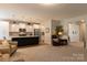 Open-concept living area flows into the kitchen, offering comfortable seating and natural light at 3156 Pinehills Way, Mount Holly, NC 28120