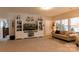 Spacious living area with built-in shelving, comfortable seating, and natural light from the window at 3156 Pinehills Way, Mount Holly, NC 28120