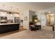 Open living space connecting to the kitchen with a comfortable recliner and view of hallway at 3156 Pinehills Way, Mount Holly, NC 28120