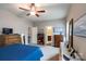 Spacious main bedroom featuring neutral paint, ceiling fan, and ensuite bathroom entrance at 3156 Pinehills Way, Mount Holly, NC 28120