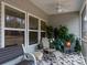 Relaxing screened porch with seating area, fan, and decorative plants at 3156 Pinehills Way, Mount Holly, NC 28120