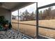 Cozy screened porch with views of the backyard and surrounding greenery at 3156 Pinehills Way, Mount Holly, NC 28120