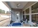Inviting screened-in porch featuring comfortable bench seating and serene outdoor views at 3156 Pinehills Way, Mount Holly, NC 28120