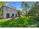 Backyard featuring a brick patio with lounge seating and dining table, backing up to a white two-story house at 332 Hempstead Pl, Charlotte, NC 28207