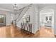 Bright foyer with hardwood floors and a staircase with white wainscoting at 332 Hempstead Pl, Charlotte, NC 28207