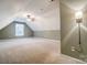 View of carpeted attic room featuring window, ceiling fan and sconce lighting at 340 Tradewinds Ln, York, SC 29745