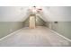 Large carpeted attic space with fan and storage hooks, plus doorway to other rooms at 340 Tradewinds Ln, York, SC 29745