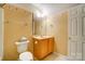 Bathroom featuring vanity and toilet with decorative wallpaper border and mirror at 340 Tradewinds Ln, York, SC 29745