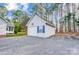 Detached garage with siding, a blue shutter, and gravel driveway at 340 Tradewinds Ln, York, SC 29745