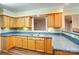 Well-appointed kitchen featuring wood cabinetry, tile backsplash, and a convenient serving bar perfect for entertaining at 340 Tradewinds Ln, York, SC 29745