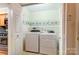 Laundry room with washer and dryer featuring shelving near the kitchen with a stovetop at 340 Tradewinds Ln, York, SC 29745