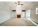 Warm living room with plush carpeting, fireplace, vaulted ceilings, and seamless flow to other living areas at 340 Tradewinds Ln, York, SC 29745