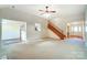 Expansive living area with plush carpet, a staircase, and an open floor plan that seamlessly connects to other spaces at 340 Tradewinds Ln, York, SC 29745