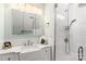 Bright bathroom features a tiled shower, bright vanity, mirror, and stainless steel accents at 3419 Wylie Meadow Ln, Charlotte, NC 28269