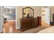 Bedroom featuring a wooden dresser, a mirror, and hardwood floors at 3419 Wylie Meadow Ln, Charlotte, NC 28269