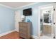 Bedroom with a dresser, TV, and a view into the bathroom at 3419 Wylie Meadow Ln, Charlotte, NC 28269