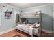 Cozy bedroom featuring a grey bunk bed and hardwood floors at 3419 Wylie Meadow Ln, Charlotte, NC 28269