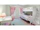 Bright bedroom features bunk beds, a desk, and pink curtains at 3419 Wylie Meadow Ln, Charlotte, NC 28269