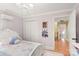 Bedroom with pink walls, hardwood floors, and access to the hallway at 3419 Wylie Meadow Ln, Charlotte, NC 28269