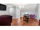 Bonus room with hardwood floors, television, games, and access to a bathroom at 3419 Wylie Meadow Ln, Charlotte, NC 28269