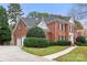 Beautiful brick home with a two-car garage, lush landscaping, and a circular driveway at 3419 Wylie Meadow Ln, Charlotte, NC 28269