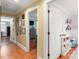 Hallway featuring hardwood floors, view into bedrooms, neutral paint, and white doors at 3419 Wylie Meadow Ln, Charlotte, NC 28269
