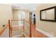 Upstairs hallway with wood floors, neutral paint, and views into various rooms through doorways at 3419 Wylie Meadow Ln, Charlotte, NC 28269