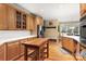 Open kitchen featuring an island, wooden cabinets, stainless steel appliances, and a breakfast nook area at 3419 Wylie Meadow Ln, Charlotte, NC 28269