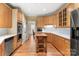 Bright eat-in kitchen features wooden cabinets, stainless steel appliances, and a wooden island on a hardwood floor at 3419 Wylie Meadow Ln, Charlotte, NC 28269
