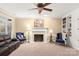 Comfortable living room with a fireplace, built-in bookshelves, and plush seating at 3419 Wylie Meadow Ln, Charlotte, NC 28269