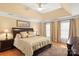 Spacious main bedroom features a tray ceiling and large windows at 3419 Wylie Meadow Ln, Charlotte, NC 28269