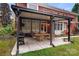 Spacious covered patio area with a large dining table, grill and outdoor television for entertaining at 3419 Wylie Meadow Ln, Charlotte, NC 28269
