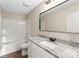 Bathroom featuring granite countertop, updated vanity, framed mirror, and shower-tub combo at 426 Holland Memorial Church Rd, Bessemer City, NC 28016