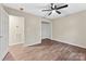 Bedroom with ceiling fan, neutral paint, view of utility area and wood-look flooring at 426 Holland Memorial Church Rd, Bessemer City, NC 28016