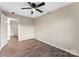 Bedroom featuring a ceiling fan, neutral paint, view of ensuite bath, and wood-look flooring at 426 Holland Memorial Church Rd, Bessemer City, NC 28016