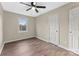 Bedroom featuring a ceiling fan, neutral paint, window, door, and wood-look flooring at 426 Holland Memorial Church Rd, Bessemer City, NC 28016