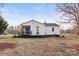 Exterior view showcases a quaint home with a screened porch and well-maintained lawn at 426 Holland Memorial Church Rd, Bessemer City, NC 28016
