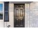 A close-up of a dark-colored front door with traditional panels and hardware at 426 Holland Memorial Church Rd, Bessemer City, NC 28016