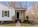 Charming front entrance with a screened porch and manicured landscaping at 426 Holland Memorial Church Rd, Bessemer City, NC 28016