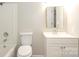 White bathroom with gold framed mirror, white vanity, tub and toilet at 4822 Spring Lake Dr # A, Charlotte, NC 28212