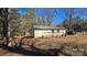 Tan brick home featuring a yard, complemented by mature trees at 509 California Cir, York, SC 29745