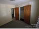 Bedroom features neutral walls and carpet, with closet doors and another room visible at 509 California Cir, York, SC 29745