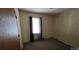 Bedroom with neutral walls, carpet flooring, a window with dark curtains, and a door on the left at 509 California Cir, York, SC 29745