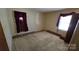 Bedroom features carpet flooring, and a window with red curtains, a door on the left at 509 California Cir, York, SC 29745