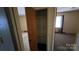 Bedroom closet with shelving, carpet flooring, and a view into an adjacent bedroom with window at 509 California Cir, York, SC 29745