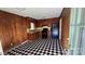 Efficient kitchen featuring wood cabinetry, black appliances, and checkered linoleum flooring at 509 California Cir, York, SC 29745