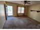 Bright living room featuring a ceiling fan, light-filled window, and access to the front porch at 509 California Cir, York, SC 29745